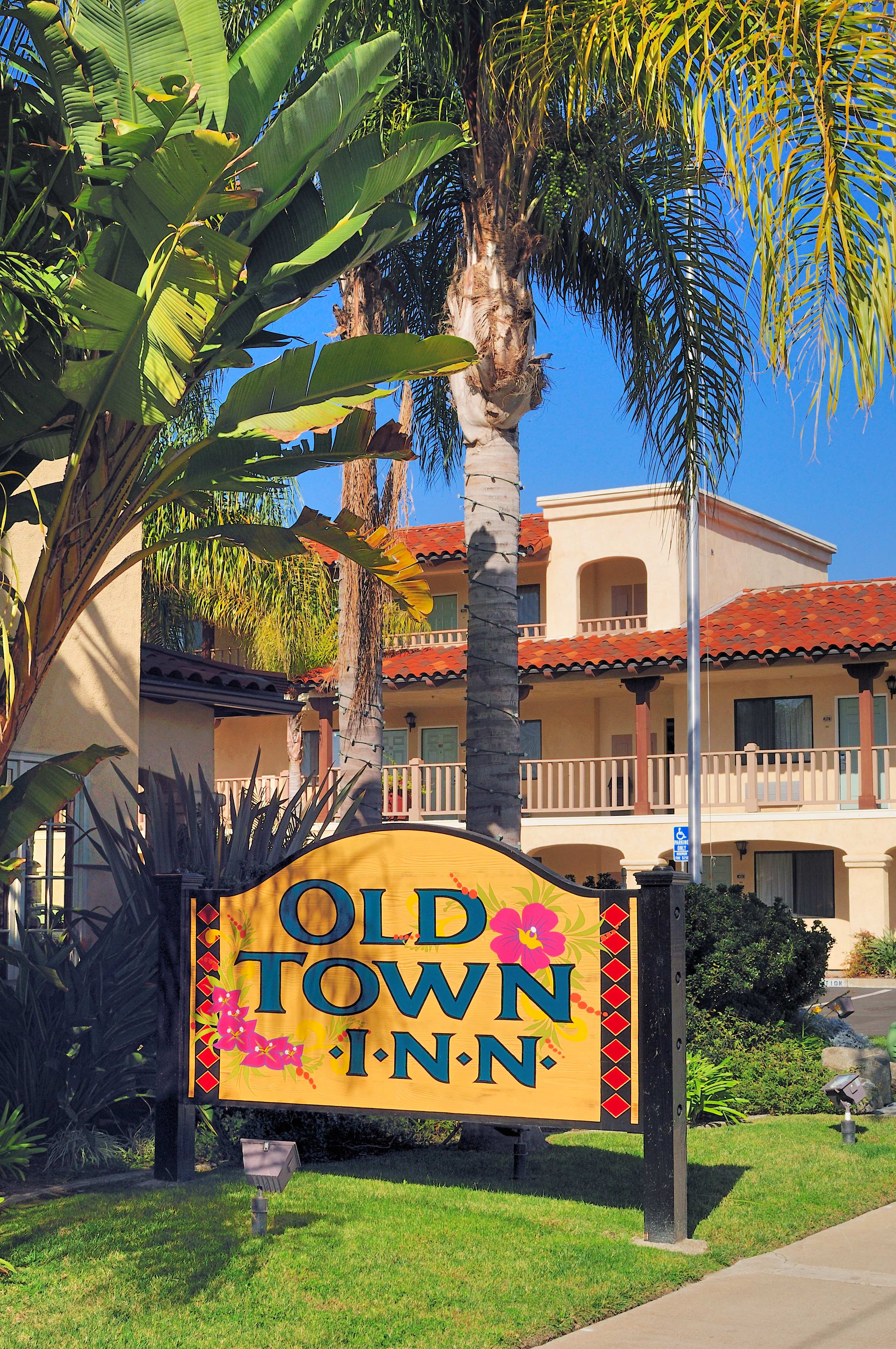 A sign reading 'Old Town Inn' in front of a building with a balcony.